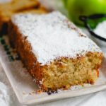 One-Bowl Apple Cake on a white plate with powdered sugar